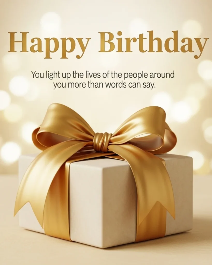 Heartfelt birthday messages and wishes image with a white gift box tied with large gold satin ribbon bow on warm cream bokeh background